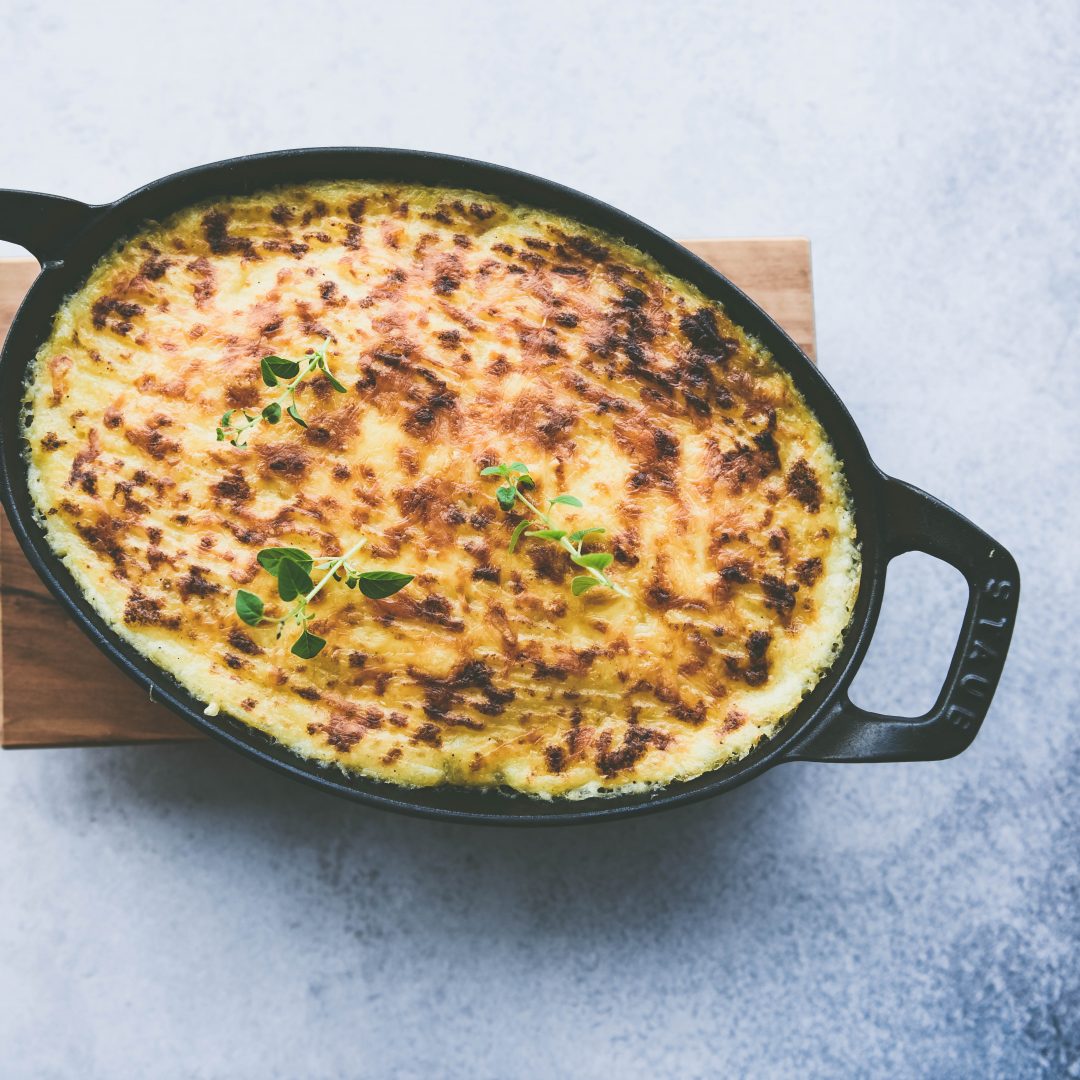 White background, black cast iron pan, top view of Spicy Shepherd's Pie