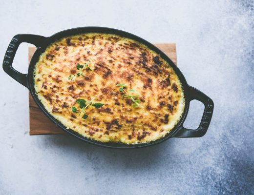 White background, black cast iron pan, top view of Spicy Shepherd's Pie