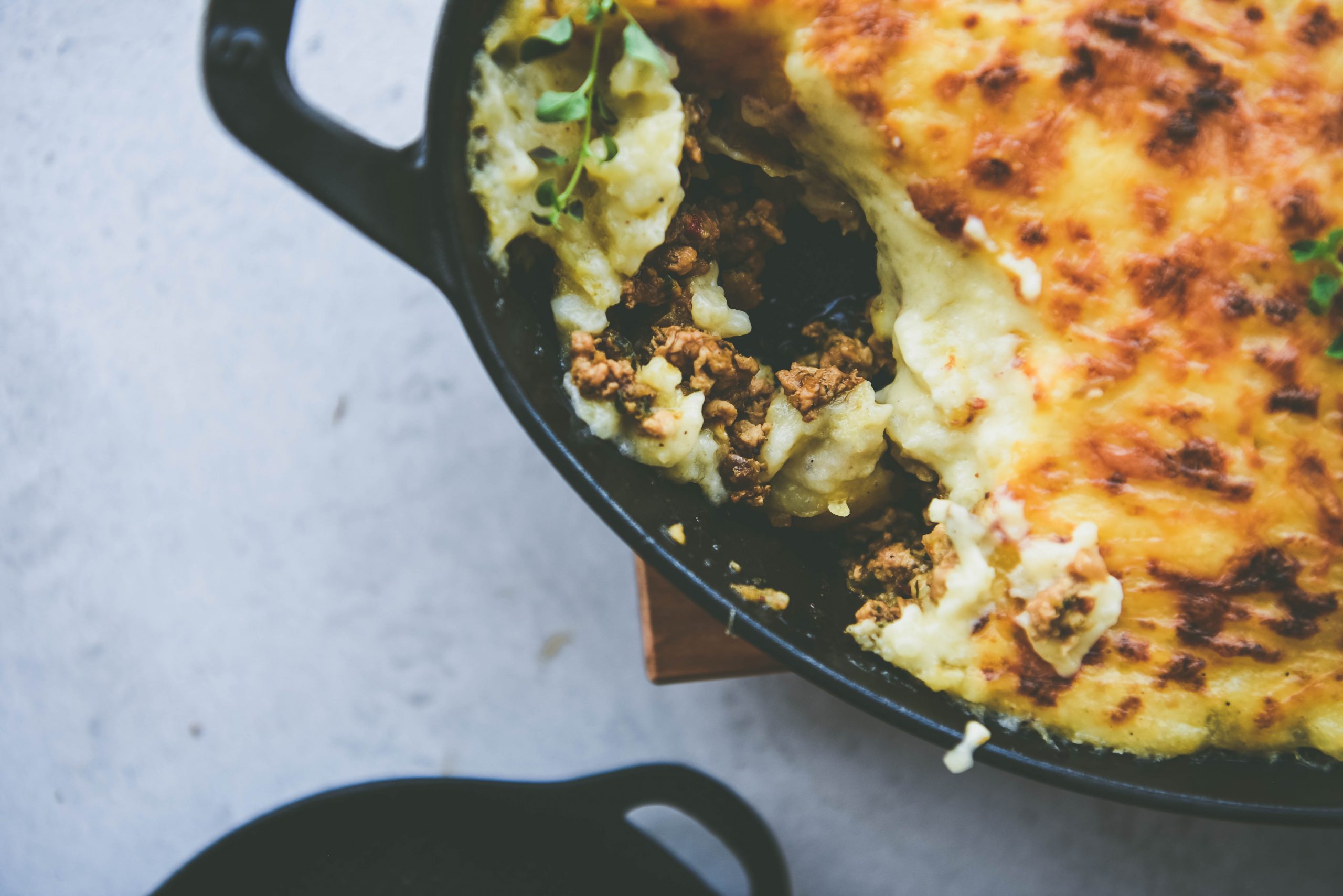 Top shot of the spiced shepherd's pie in a black pan.